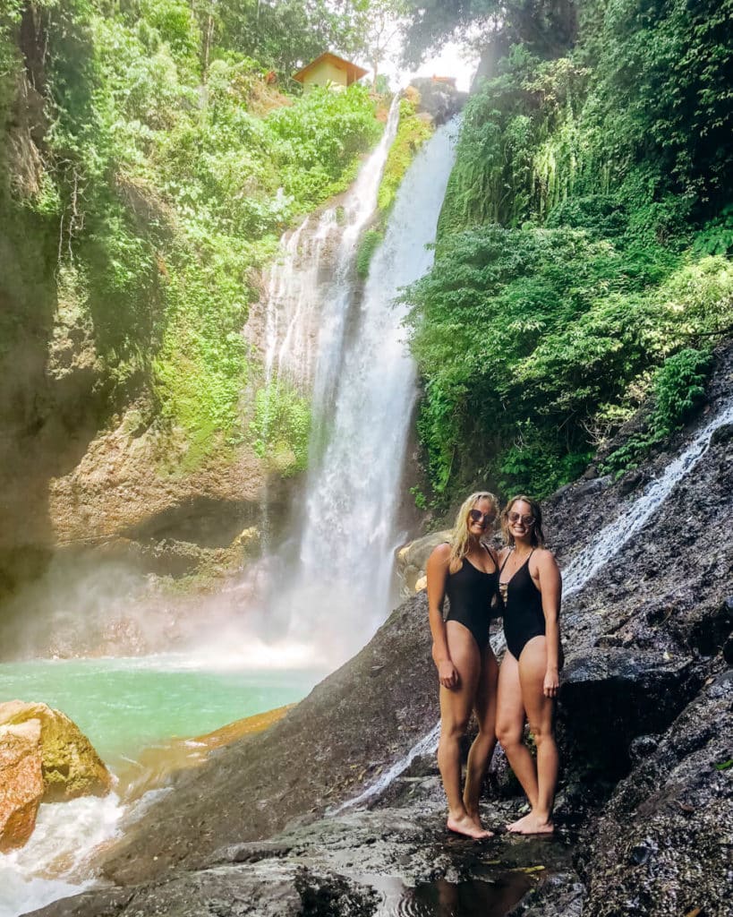 girls in front of waterfall in Bali