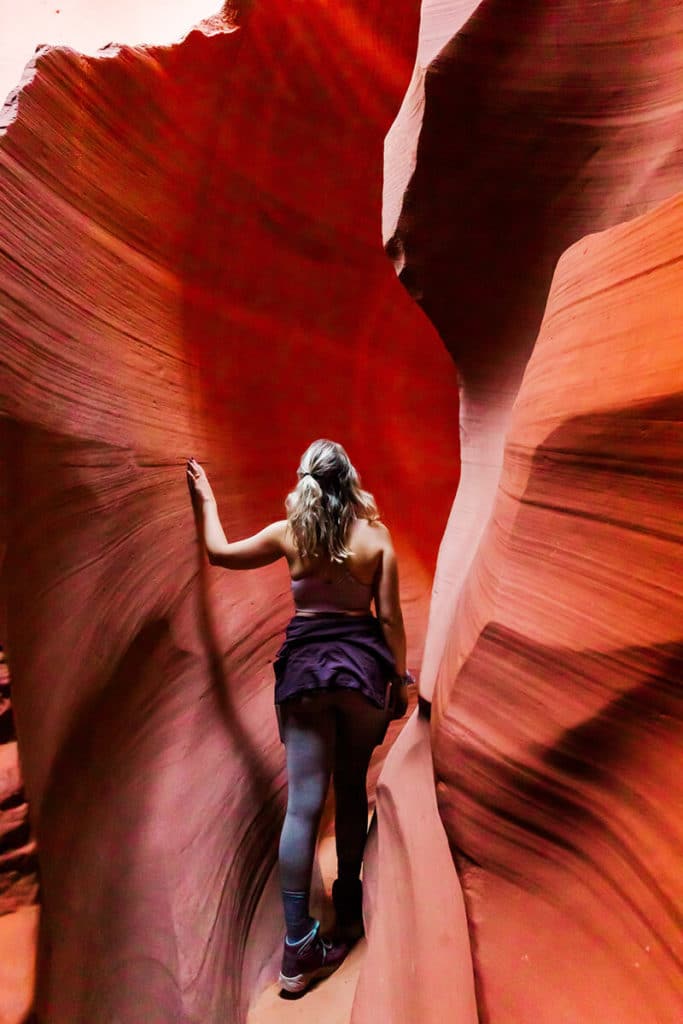 girl walking through antelope canyon