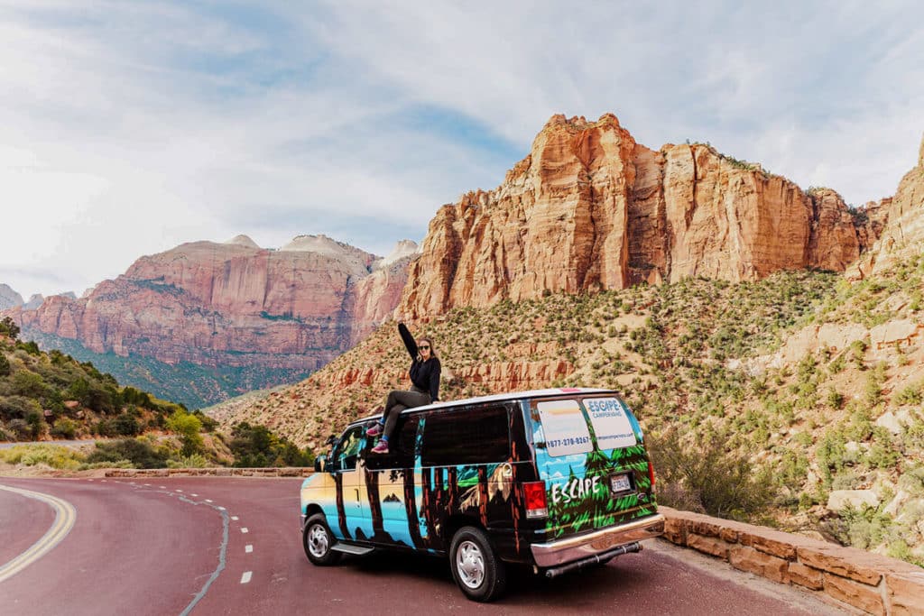 girl sitting on campervan on Grand Canyon, Zion, Bryce road trip