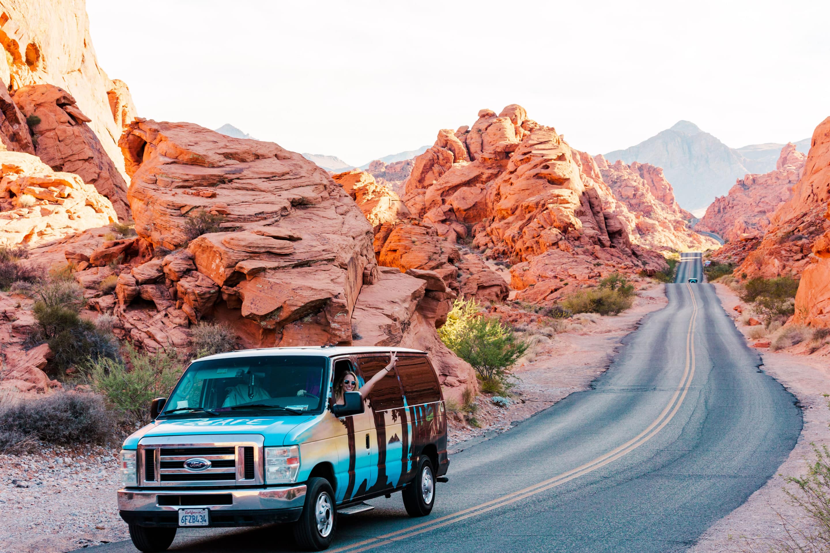 Girl hanging out of Escape Campervan in Valley of Fire