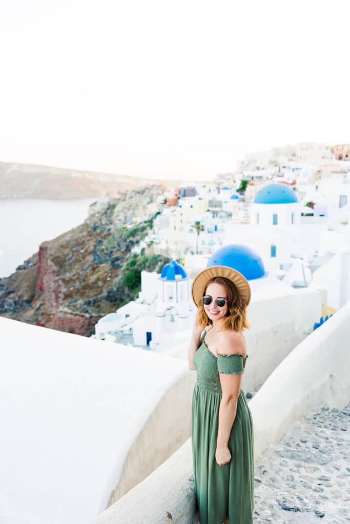 girl standing in front of white calderas in Greece