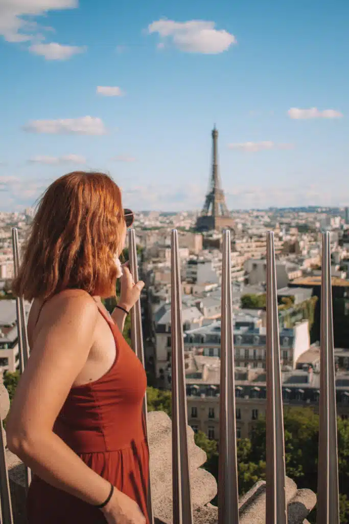 girl on rooftop looking at Eiffel Tower