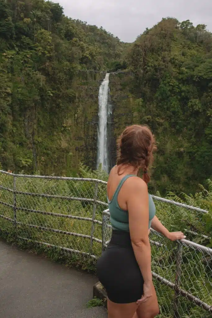 girl standing in front of waterfall in Hawaii