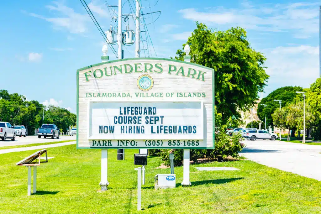 light green sign for Founders Park on an grassy side of road in Islamorada Florida