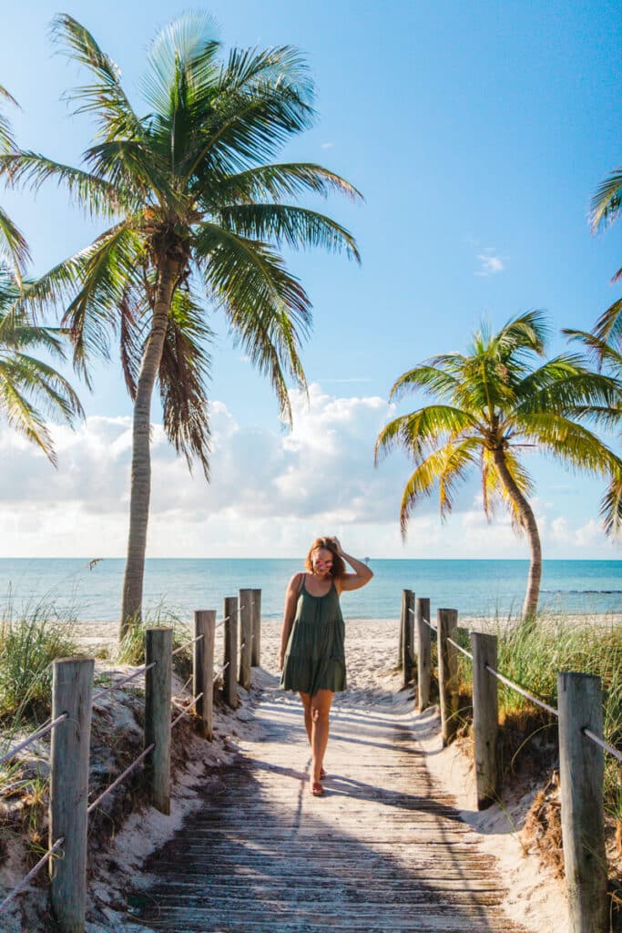 girl walking along boardwalk on Smathers Beach in Key west