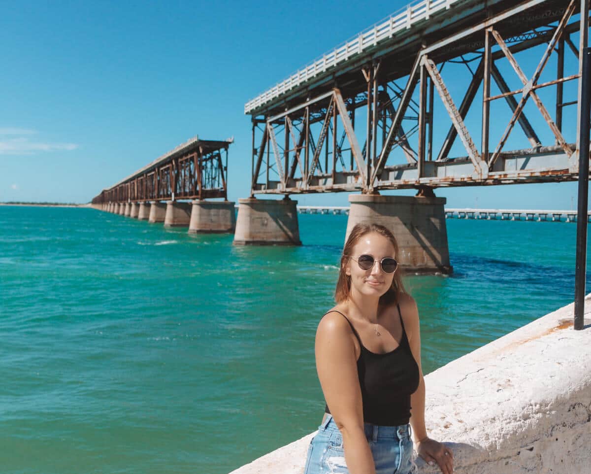 girl standing in front of old railway bridge in the Florida Keys