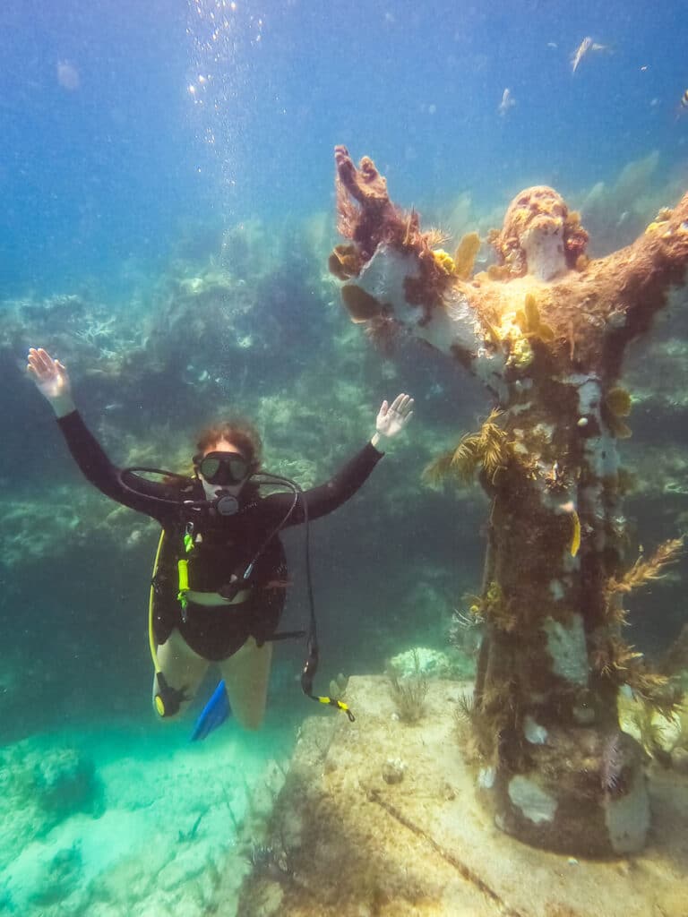 girl snorkeling Key Largo next to Christ Statue