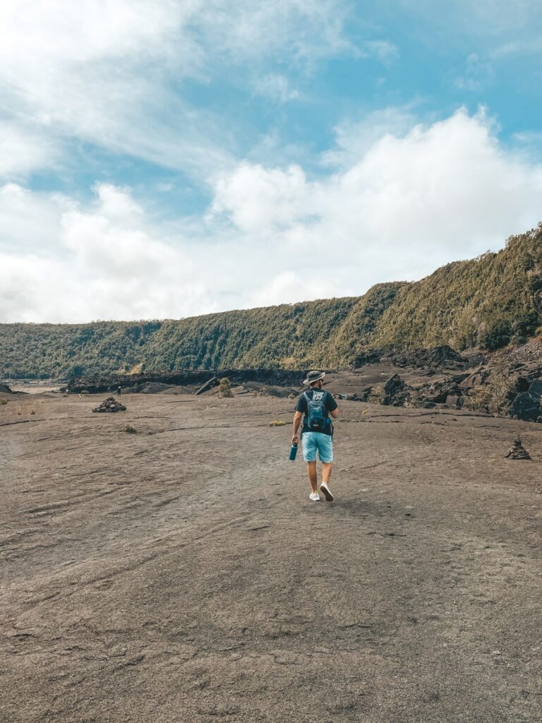 Man walking across lava filed in Hawaii