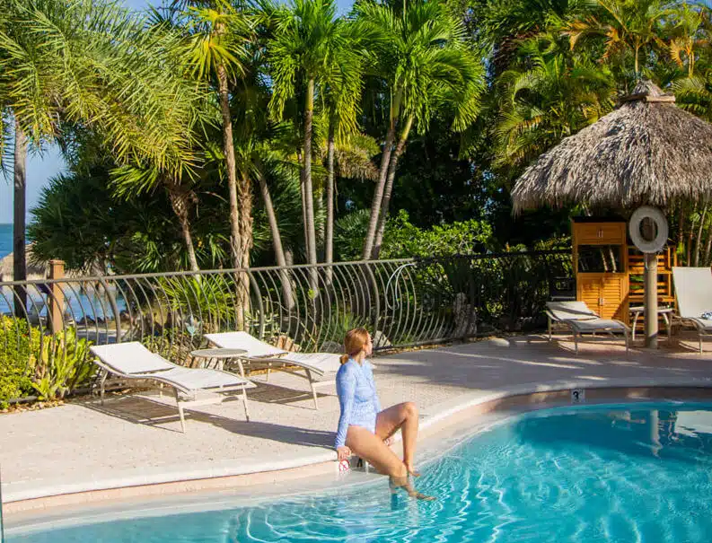 girl sitting with feet in pool Florida Keys
