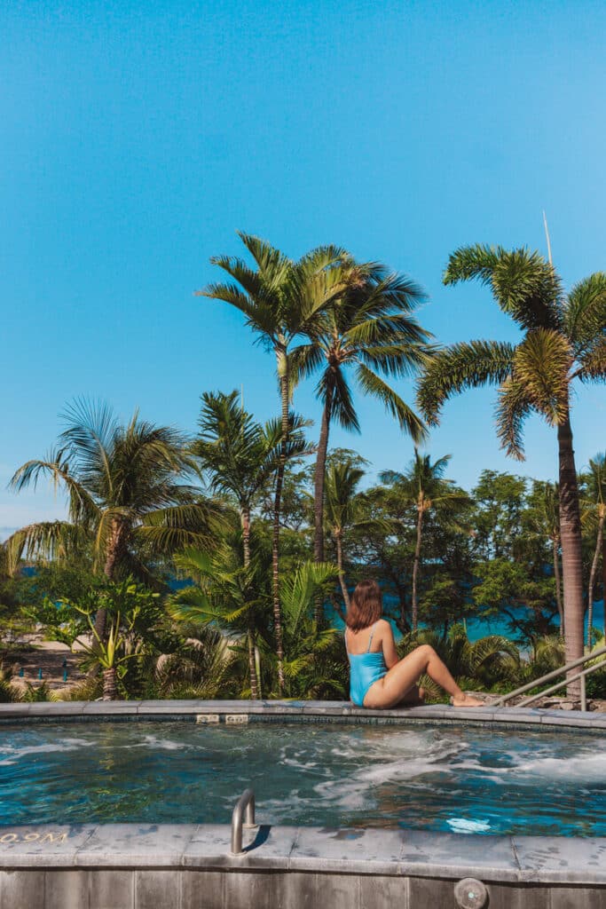girl sitting on pool deck in Hawaii