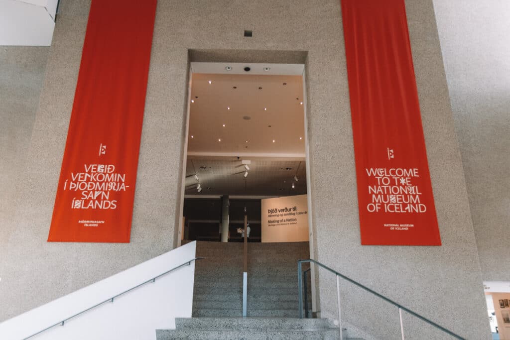 front entrance of the National Museum of Iceland, with red banners on either side of the doorway