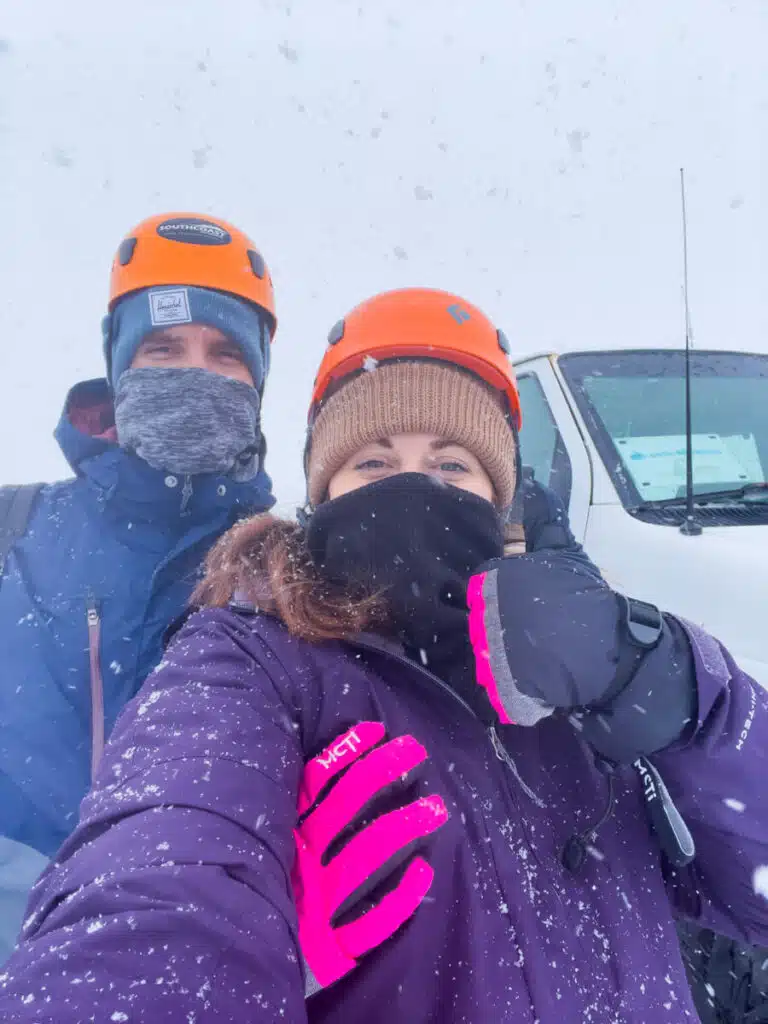 couple in winter gear giving thumbs up to the camera at the beginning of a Katla Ice cave tour in Iceland