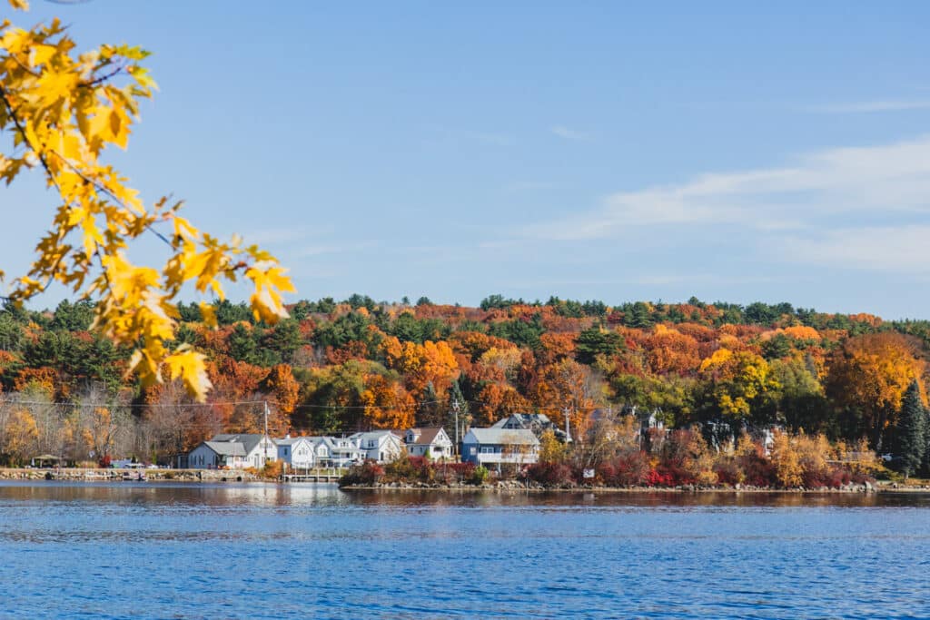 fall foliage and houses on Meredith Bay on Lake Winnipesaukee, New Hampshire