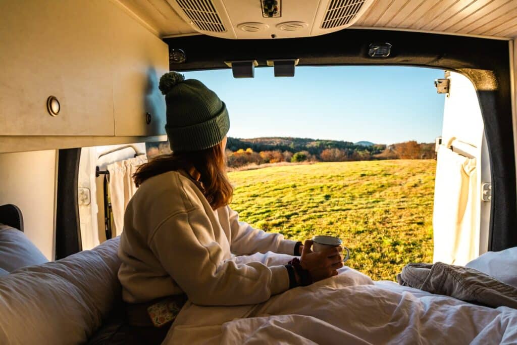 girl in campervan looking out Woodstock, Vermont