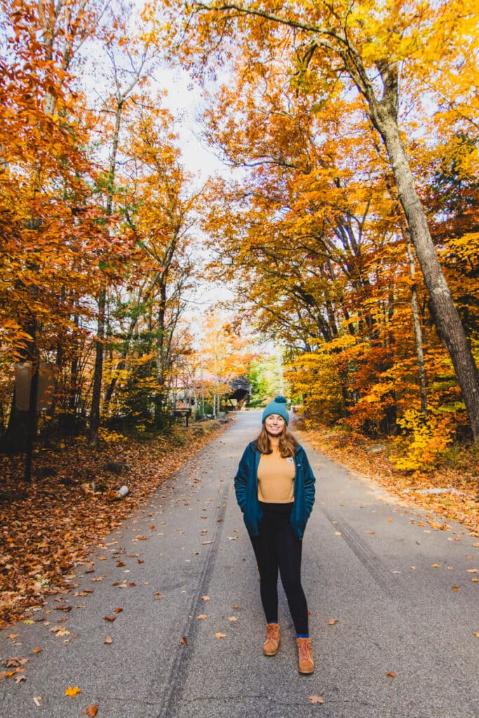 girl in road with fall foliage in White Mountains New Hampshire