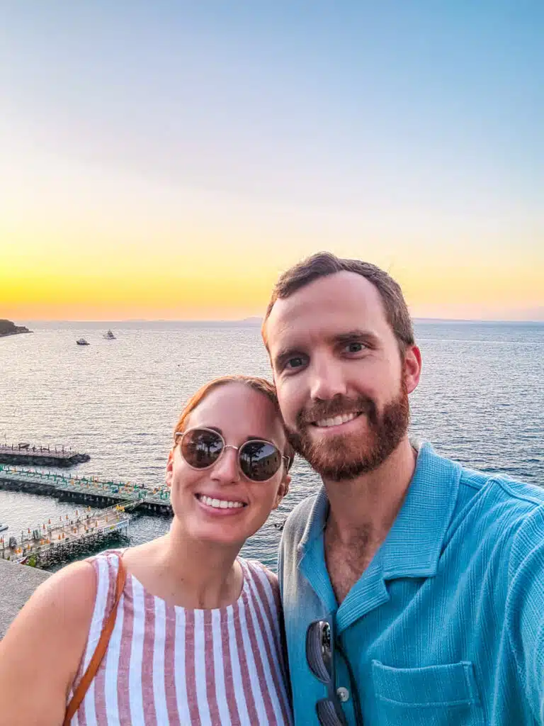 Couple smiling at sunset with panoramic views over the sea in Sorrento