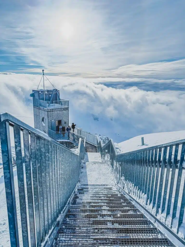 metal stairway above the clouds covered in snow at the top of the Matterhorn Glacier Paradise in Switzerland