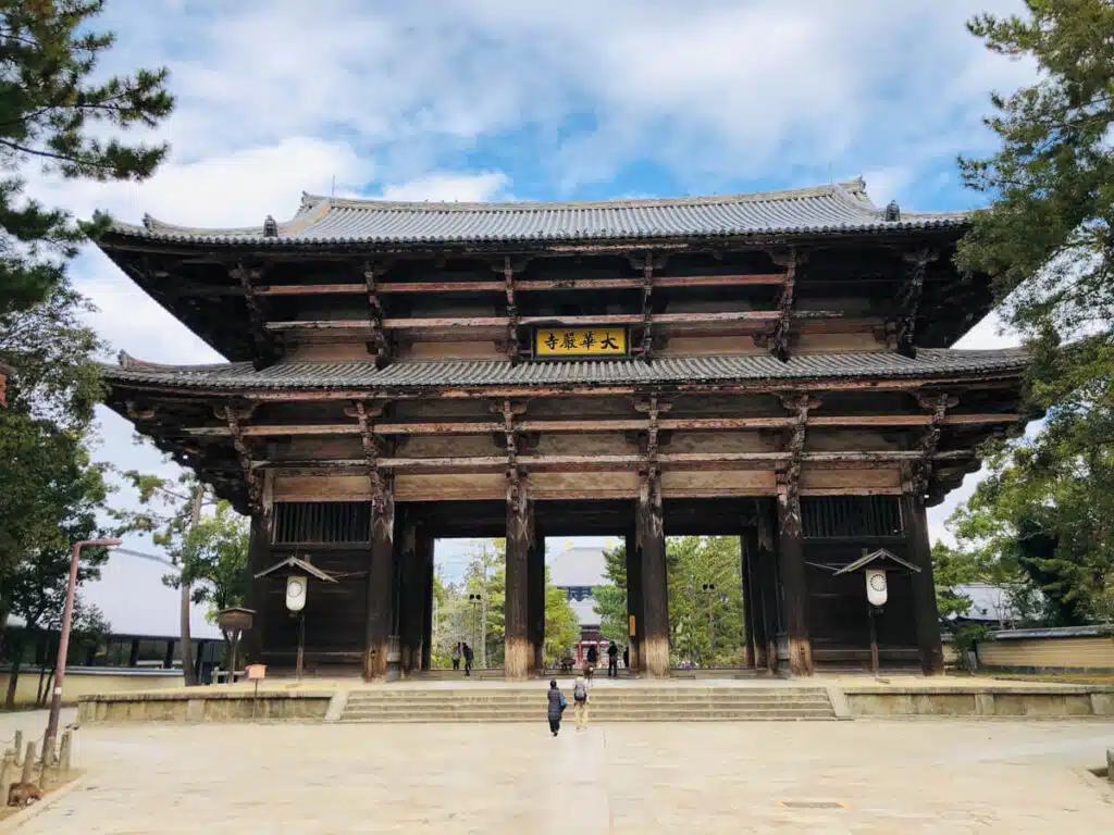 Nandaimon Gate at Todai-ji Temple in Nara, Japan, stands tall with its wooden frame and tiled roof, welcoming visitors into the historic complex.