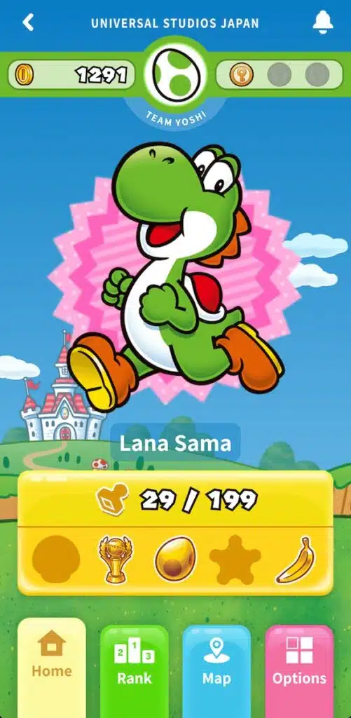 Screenshot of Universal Studios Japan in Osaka mobile app showing a green Yoshi character centered on screen with the text "UNIVERSAL STUDIOS JAPAN" "TEAM YOSHI" "Lana Sama" and "29 / 199". Navigation buttons at the bottom read "Home" "Rank" "Map" and "Options" with colorful icons.