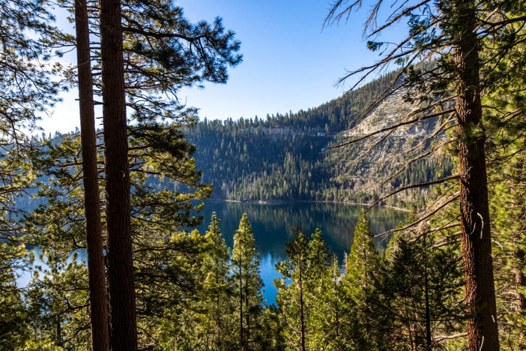 view of Emerald Bay through the trees along the hike down to the Bay