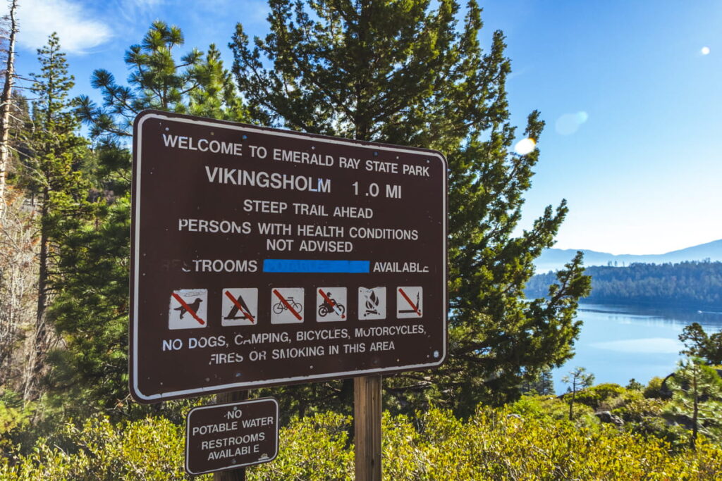 sign stating "Welcome to Emerald Bay State Park" showing the distance down to Vikingsholm Castle with warnings