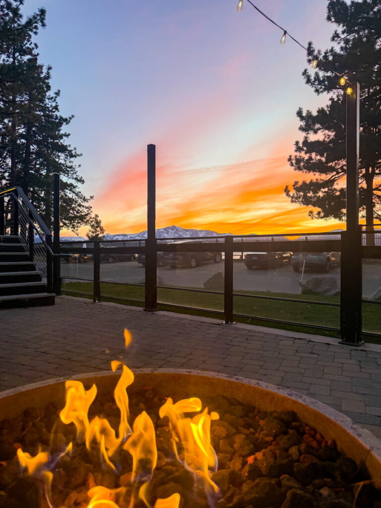 view of patio with fireplace in the foreground and beautiful sunset in the background. Taken at the Landing Resort and Spa