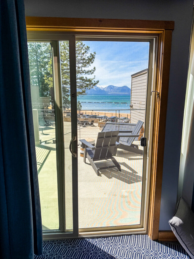 door from inside hotel room at the Landing Resort and Spa in Lake Tahoe, looking out to the balcony with the lake in the background