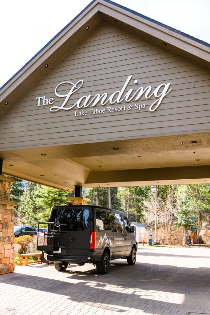 exterior shot of the entrance to the Landing Resort and Spa in Lake Tahoe with free shuttle bus parked outside