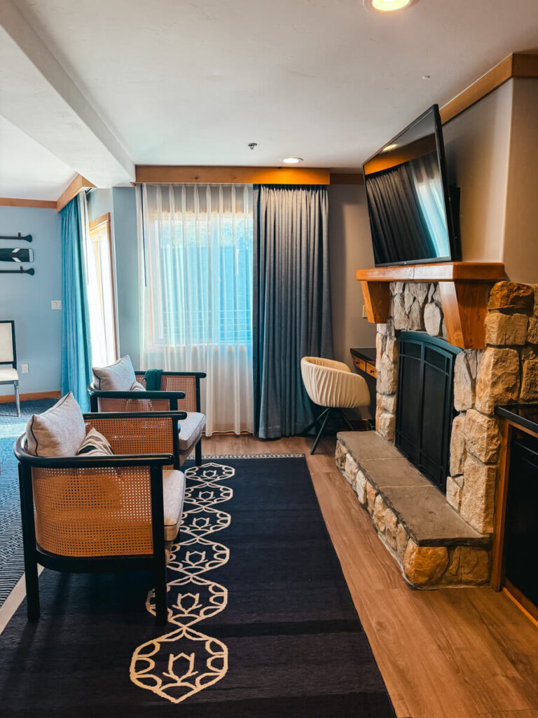 interior room shot of the Landing Resort and Spa showing a fireplace, tv, and two chairs