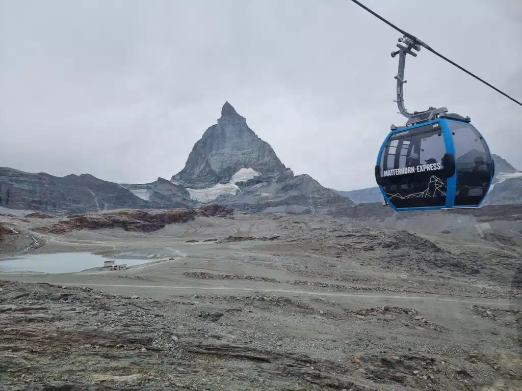 view of the matterhorn with gray rocky area in front of it and Matterhorn Glacier paradise gondola in the foreground