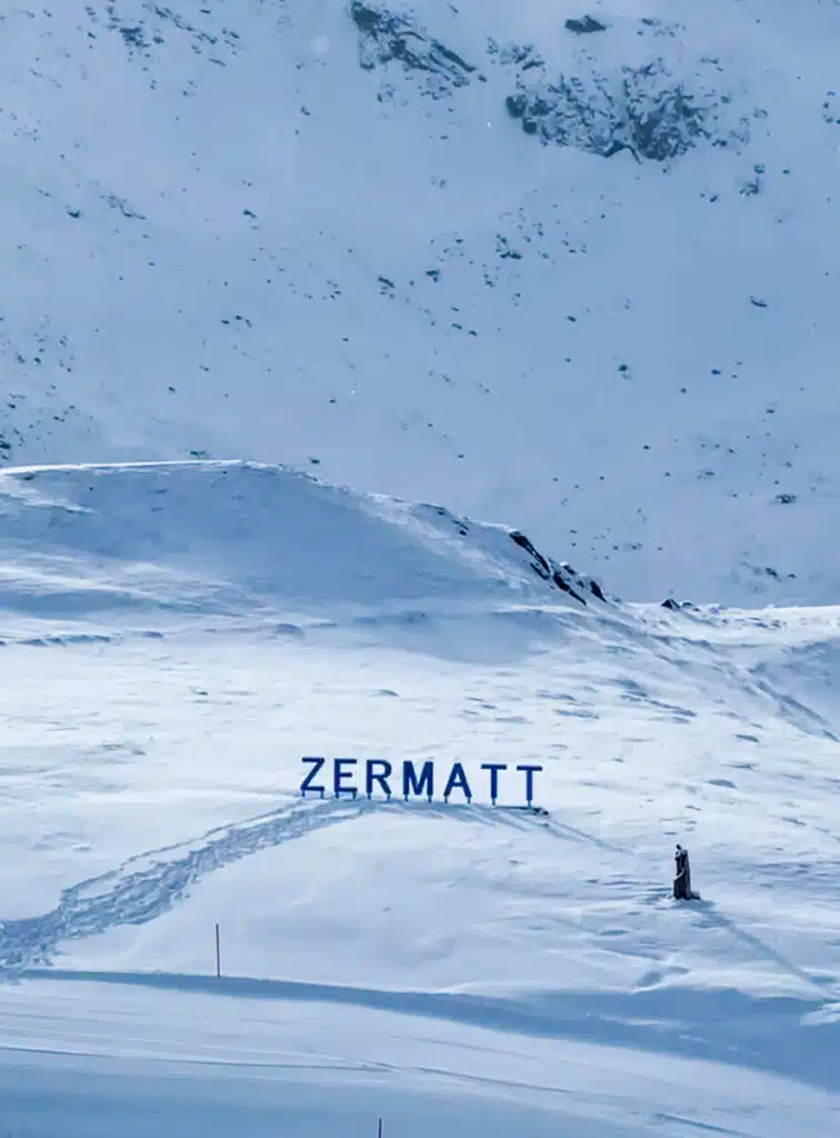 small blue ZERMATT letters in the snow, taken in front of the Matterhorn at the Schwarzsee stop of the Matterhorn Glacier Paradise