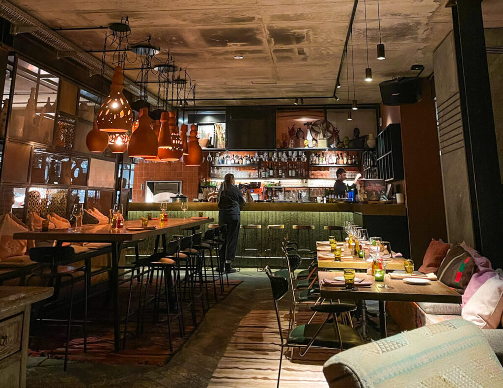 colorful tables and bar inside of Bazaar Restaurant at the Cervo Mountain Resort in Zermatt, Switzerland